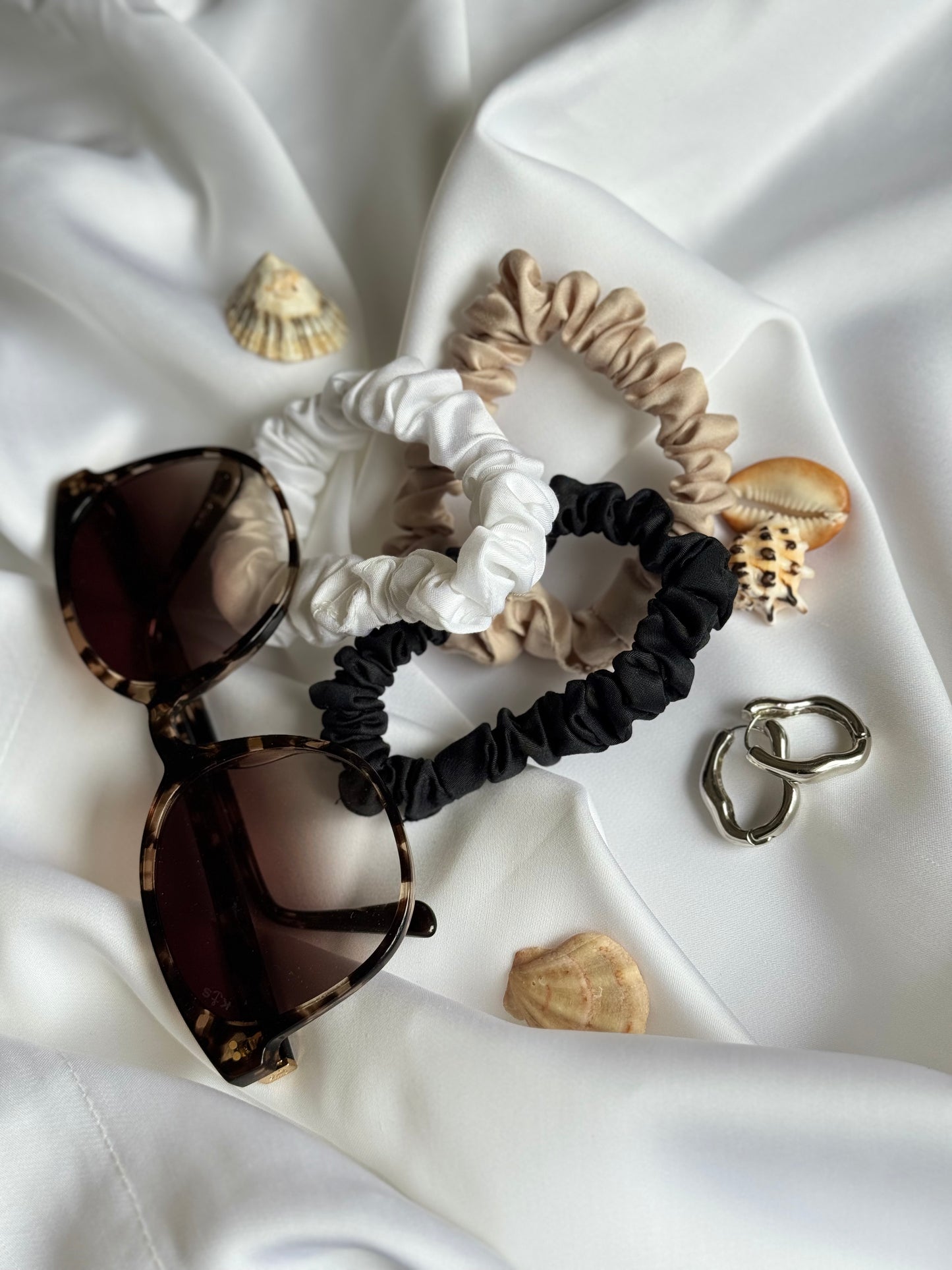 BetterBe bamboo scrunchie flat lay with soft shadows, cruelty free accessory for hair
