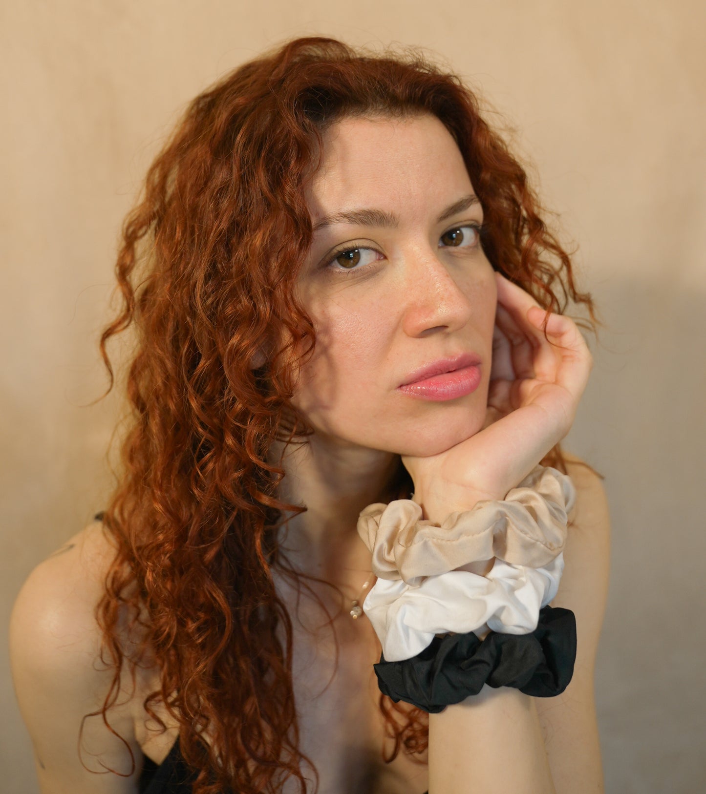 Redhead model portrait with BetterBe bamboo scrunchie accessory, natural curls highlighted