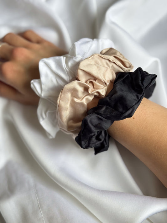 Close up of BetterBe bamboo scrunchies set, Raven Black Pearl White and Bubbly Champagne