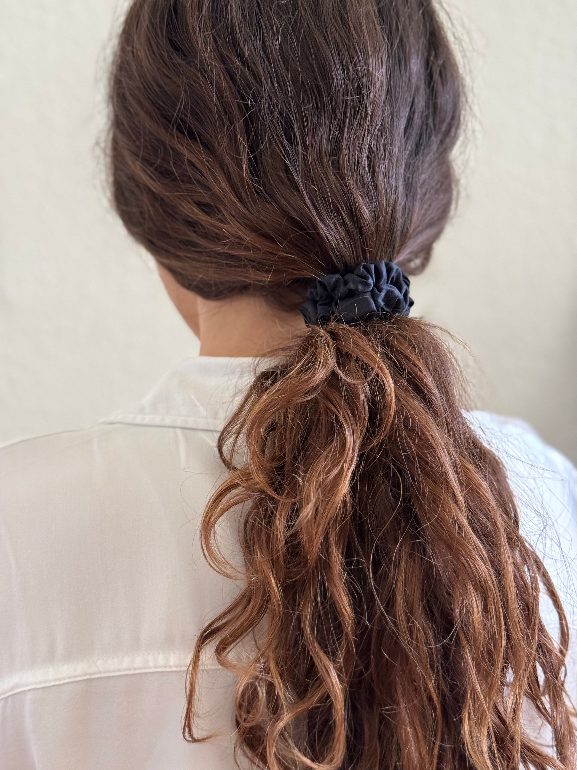 Side braid secured with BetterBe bamboo scrunchie, gentle hold that protects strands