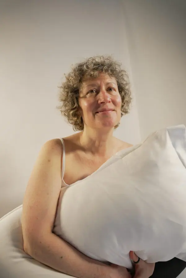 DSC00323 Woman with short blonde curls holding a pillow
