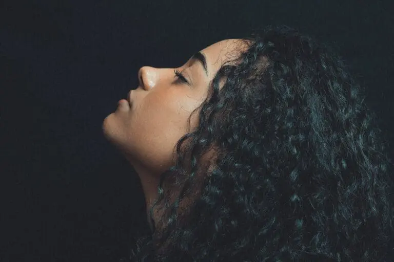 woman with curls black background